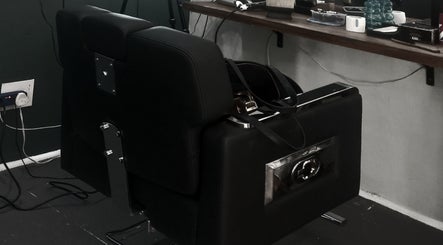 Sleek black barber chair at Barber On Wheels, Gqeberha, Eastern Cape, ZA, ready for a stylish haircut.