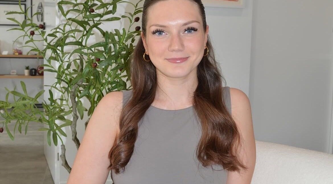 Woman smiling at Lash Artistry by Mikayla, Melbourne, Victoria, AU, showcasing inviting salon atmosphere.