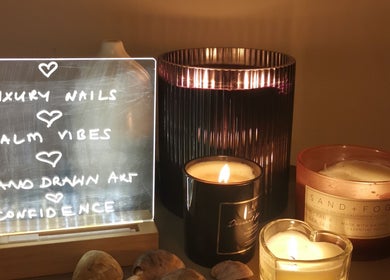 Illuminated sign and candles at Ever Luxe Nails in Bilston, Scotland, GB, creating a calming ambiance.