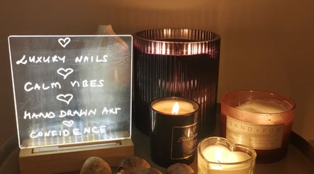 Illuminated sign and candles at Ever Luxe Nails in Bilston, Scotland, GB, creating a calming ambiance.
