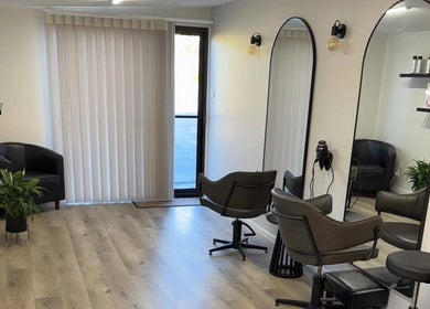 Modern interior of Studio MB Hair in Cowra, New South Wales, AU, featuring elegant salon chairs and large mirrors.