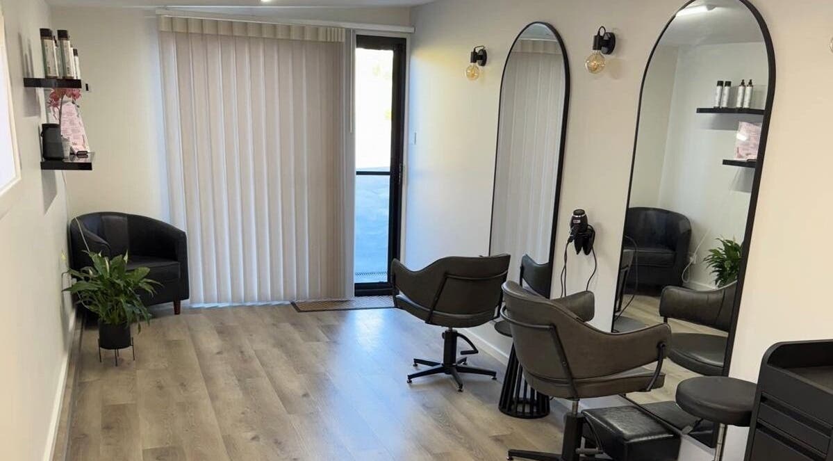 Modern interior of Studio MB Hair in Cowra, New South Wales, AU, featuring elegant salon chairs and large mirrors.