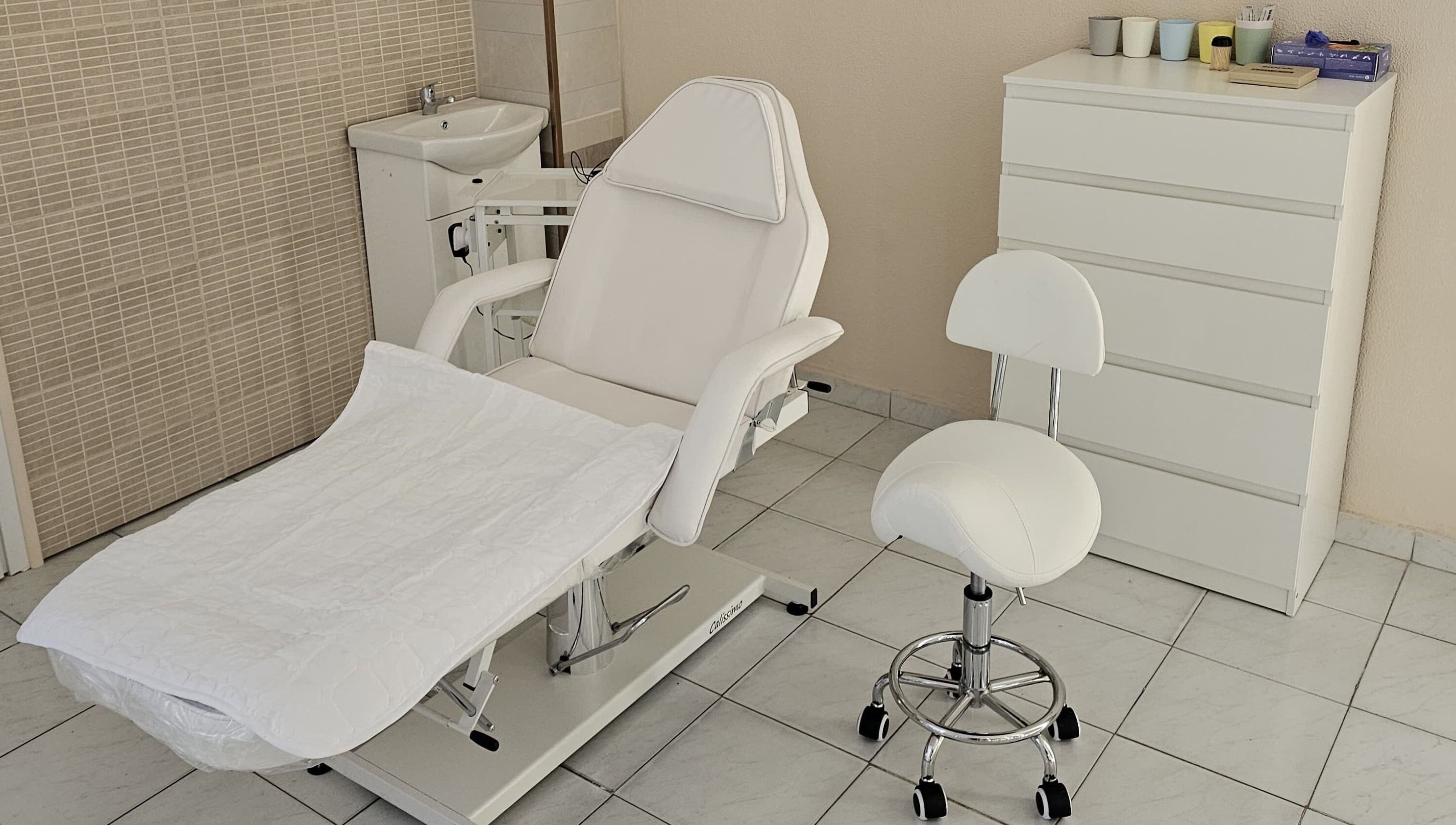 Λευκή καρέκλα και έπιπλο στο Art Touch, Ilioupoli, GR για υπηρεσίες ομορφιάς.