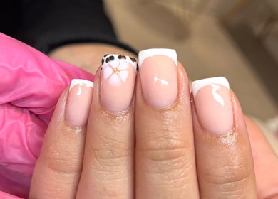 Chic French manicure with floral detail at Glossy Nails, Pontypridd, Wales, GB.