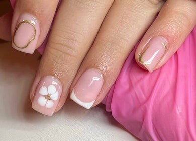 Elegant nail art with floral design and gold accents at Glossy Nails, Pontypridd, Wales, GB.