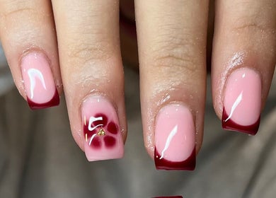 Stylish pink and red nail art at Glossy Nails, Pontypridd, Wales, GB. Perfectly manicured hands showcasing elegance.