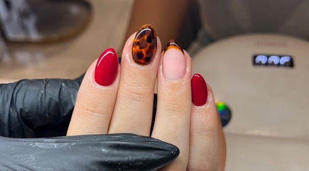 Trendy red and tortoise shell nails at Glossy Nails, Pontypridd, Wales, GB.