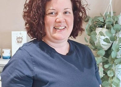 Therapist at Elara Holistic Therapies, Rutherglen, Scotland. Cozy interior with plants.