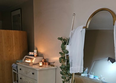 Serene therapy room at Elara Holistic Therapies in Rutherglen, Scotland, GB with candles and soft lighting.