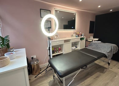 Be Defined Beauty in Billinge, England, GB, showcases a calming treatment room with modern decor and professional setup.