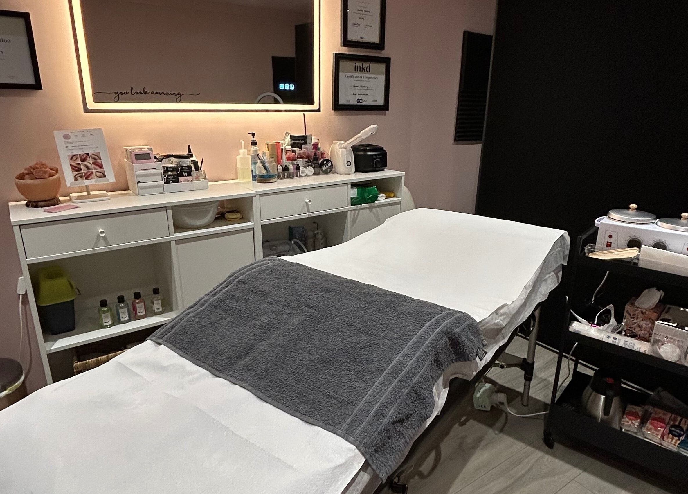Relaxing beauty treatment room at Be Defined Beauty in Billinge, England, GB, featuring a cozy treatment bed.