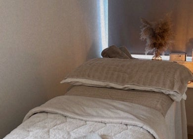 Cozy massage bed at Skin and Sculpt by Victoria Cottle, Honiton, England, GB, offering a tranquil ambiance.
