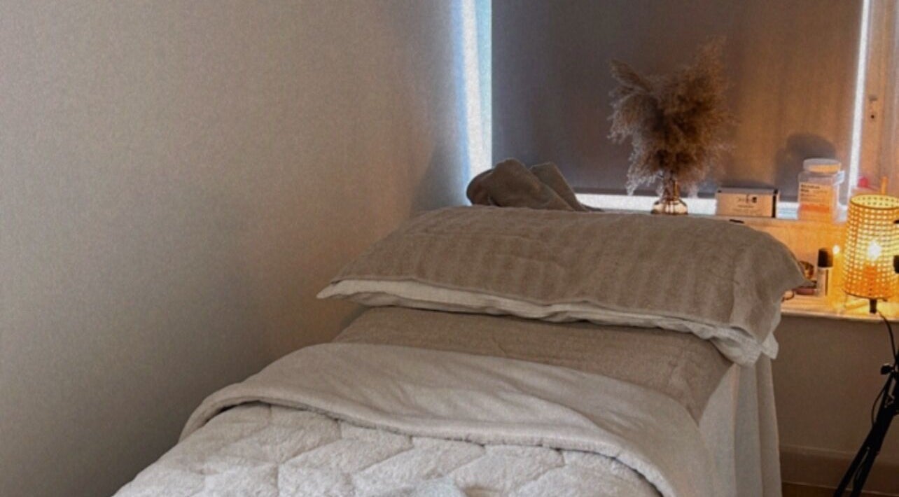 Cozy massage bed at Skin and Sculpt by Victoria Cottle, Honiton, England, GB, offering a tranquil ambiance.