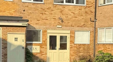 Entrance of Extendedbyg wellness center in Doncaster, England, GB with warm brick facade and green door.