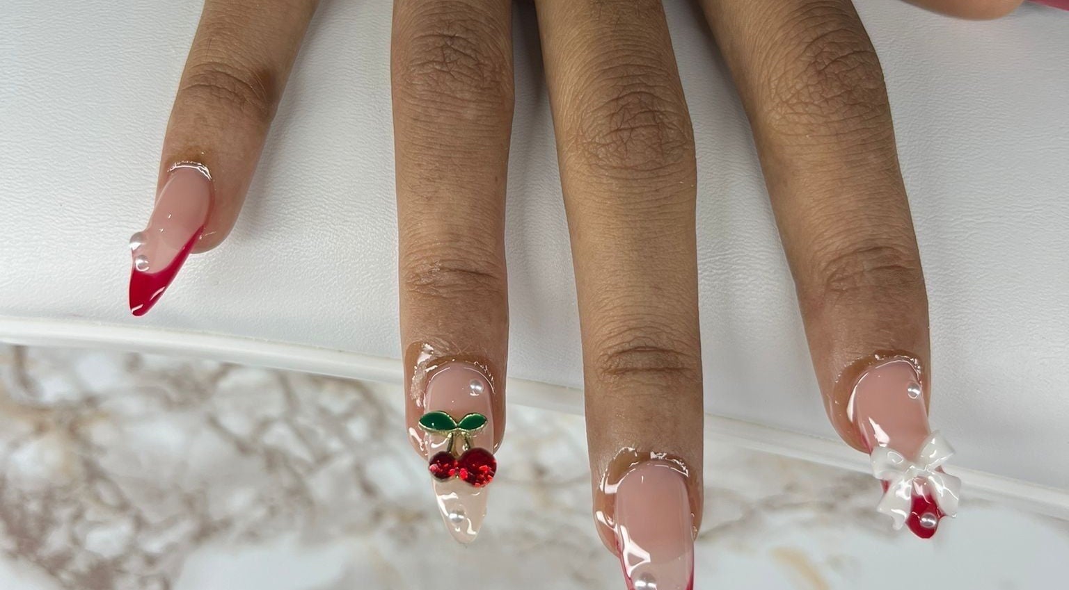 Stylish cherry-themed nail art at Chrissy Aestheticss, Bridgetown, Saint Michael, BB.