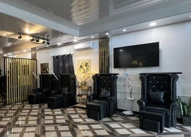 Elegant interior of DC Beauty Lounge in Mangatarem, Ilocos Region, PH with black seating and modern decor.