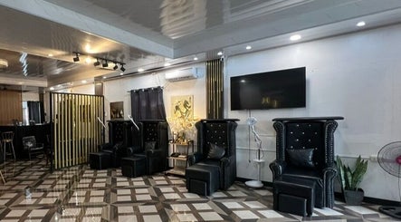 Elegant interior of DC Beauty Lounge in Mangatarem, Ilocos Region, PH with black seating and modern decor.