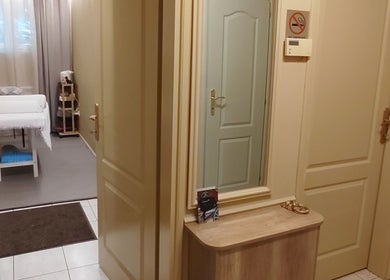 A serene massage room at Biomechanic Jana in Београд, RS, featuring a massage table and soft curtains.