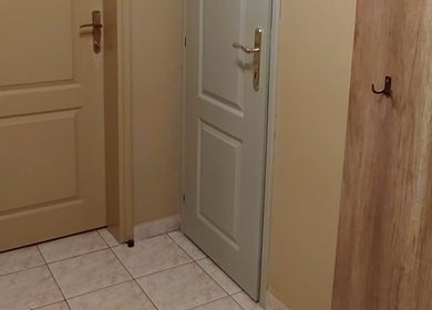 Entrance with wooden coat hooks at Biomechanic Jana, Београд, RS.