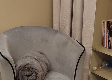 Comfy chair with blanket at Biomechanic Jana, Београд, RS, offering a relaxing atmosphere.