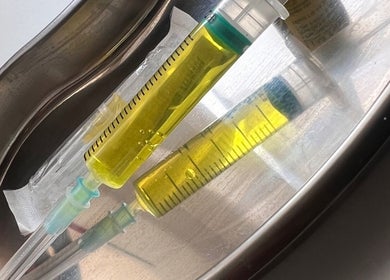 Yellow syringes at Glowaestheticbyjaz, London, England, GB highlighting professional beauty treatments.