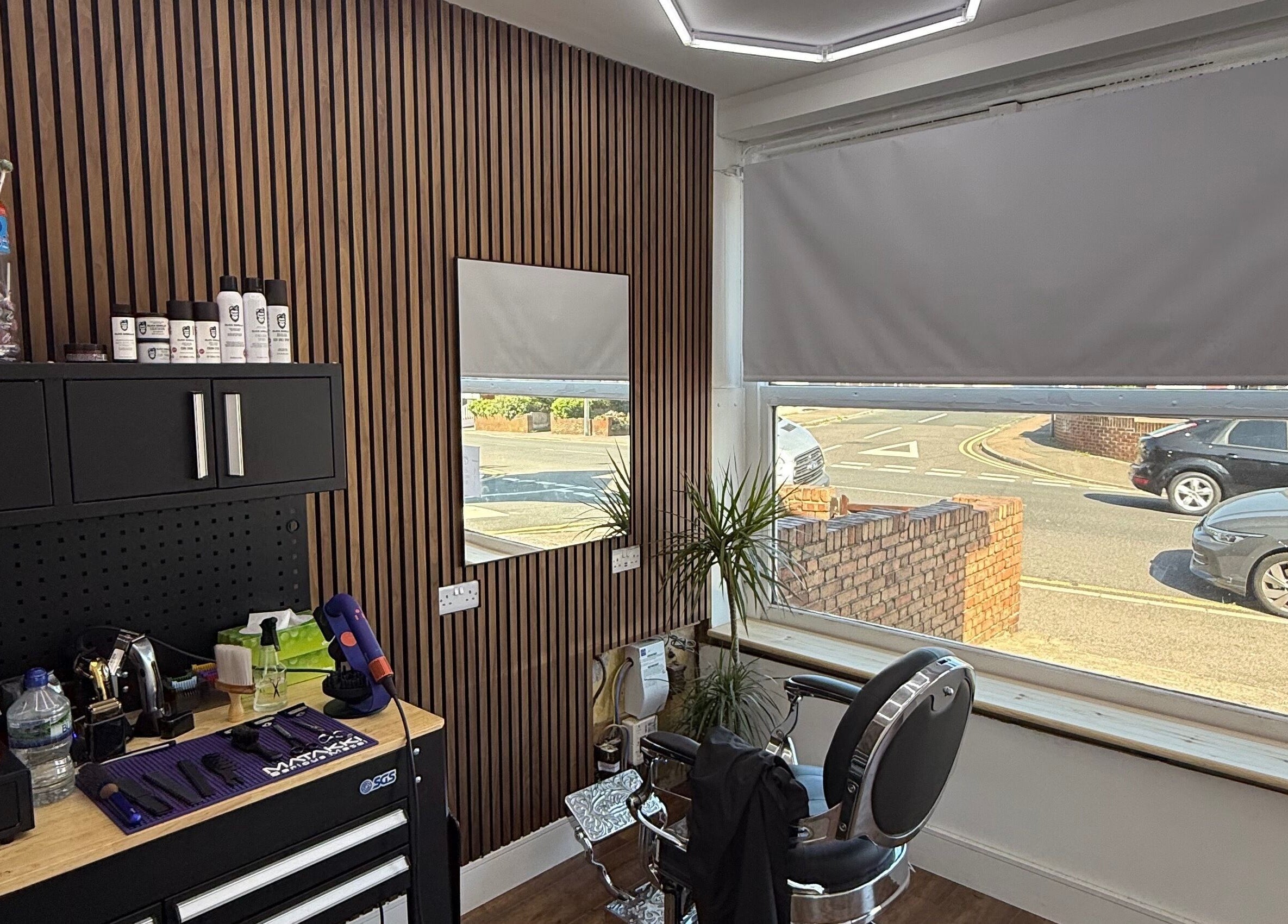 Interior view of Stokes Cuts in Broadstairs, England, showing a modern salon chair and grooming tools.