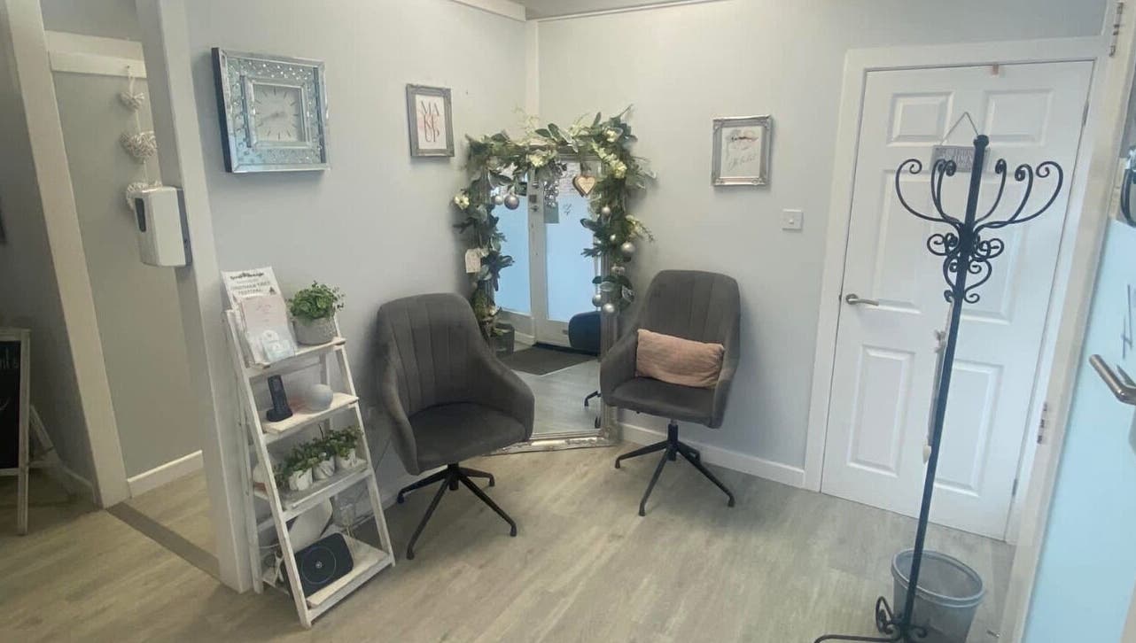 Inviting interior at Total Aesthetics Clinic, Wisbech, England, GB featuring plush chairs and decorative mirror.