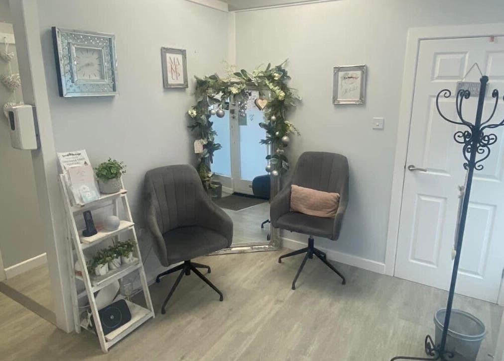 Inviting interior at Total Aesthetics Clinic, Wisbech, England, GB featuring plush chairs and decorative mirror.