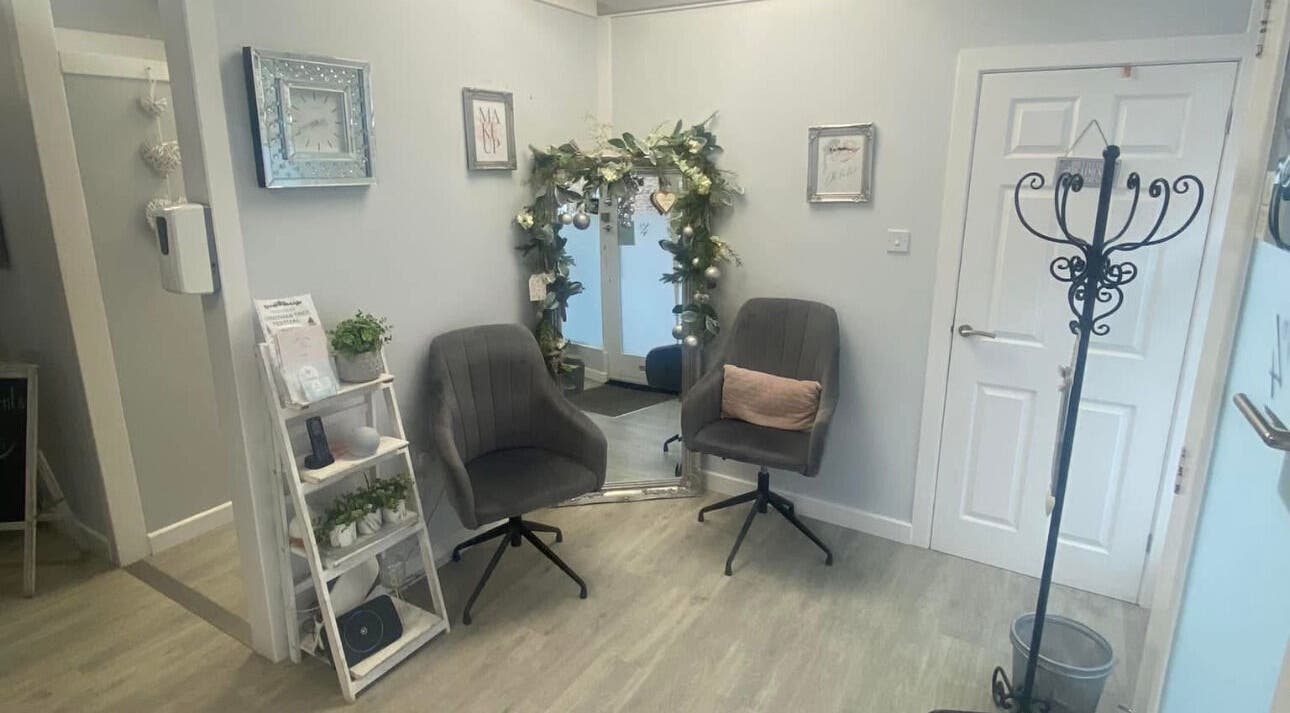 Inviting interior at Total Aesthetics Clinic, Wisbech, England, GB featuring plush chairs and decorative mirror.