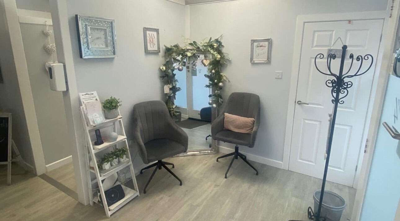 Inviting interior at Total Aesthetics Clinic, Wisbech, England, GB featuring plush chairs and decorative mirror.