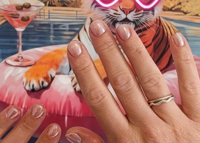Glowing nails styled at Off The Clock Nails, Bryncae, Llanharan, Wales, GB with a playful backdrop.