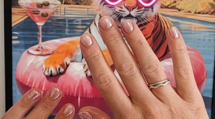 Glowing nails styled at Off The Clock Nails, Bryncae, Llanharan, Wales, GB with a playful backdrop.
