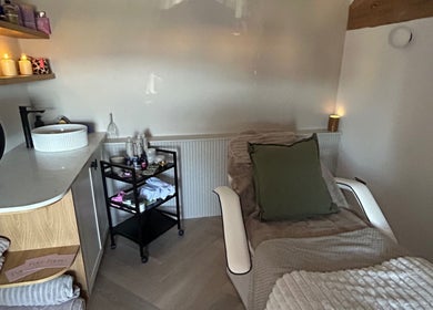 Comfortable treatment room with soft lighting and decor at Pause Beauty & Holistic, Chew Magna, England, GB.