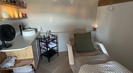 Comfortable treatment room with soft lighting and decor at Pause Beauty & Holistic, Chew Magna, England, GB.