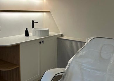 Treatment room at Pause Beauty & Holistic, Chew Magna, England, GB featuring a cozy chair and modern sink.