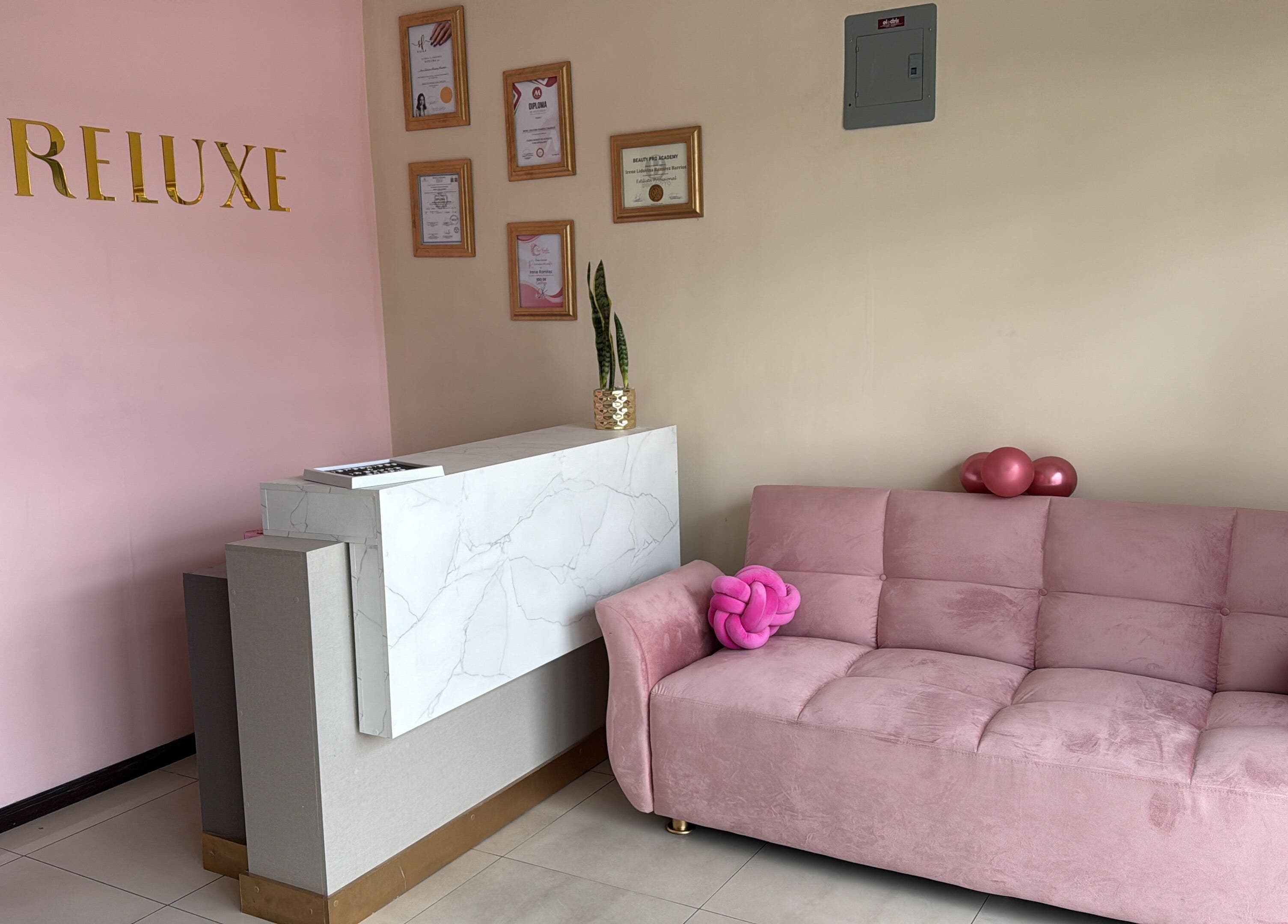 Recepción de Ireluxe Studio en San Marcos, San Marcos, GT con sofá rosa y decoraciones elegantes.