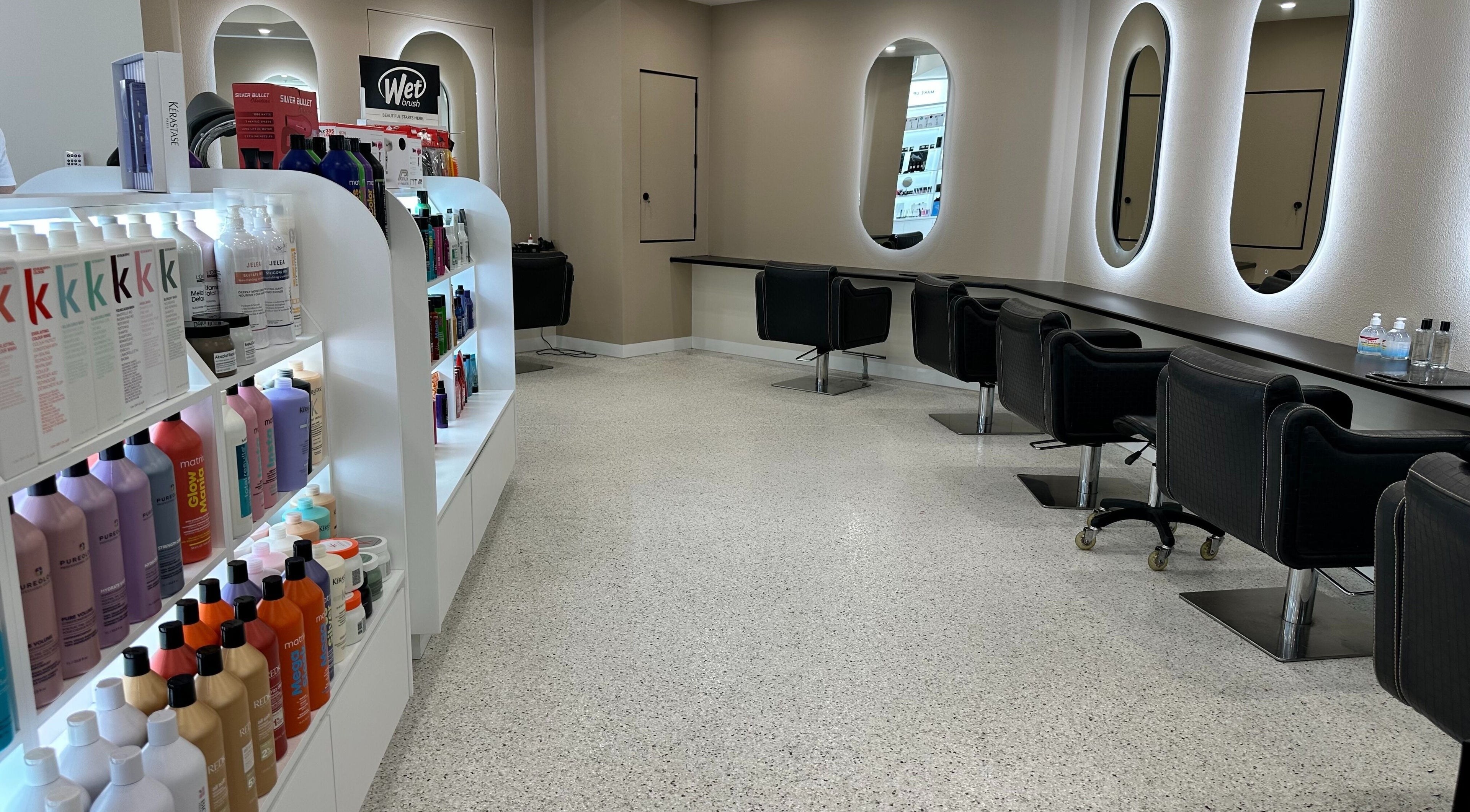 Modern interior of SALON HQ, Warriewood, New South Wales, AU, featuring sleek styling stations and premium products.