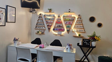 Nail polish display and manicure station at Nominnie Beauty, Bloemfontein, Free State, ZA. Modern and inviting space.