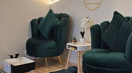 Luxurious seating with green velvet chairs at Nominnie Beauty, Bloemfontein, Free State, ZA.