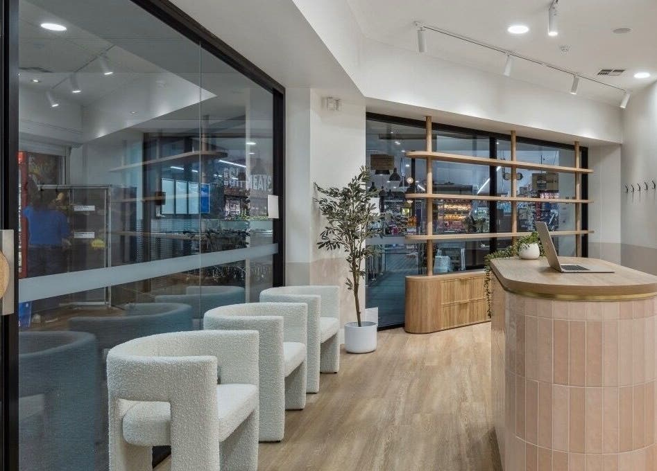 Elegant reception area of La Lueur Salon, Adelaide, South Australia, AU with chic chairs and modern decor.