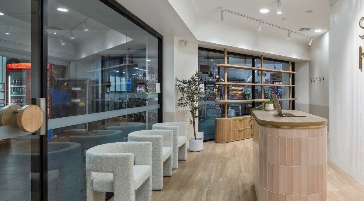 Elegant reception area of La Lueur Salon, Adelaide, South Australia, AU with chic chairs and modern decor.