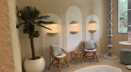 Cozy seating area with palm decor at Beach Spa Social, Kuala Lumpur, Wilayah Persekutuan Kuala Lumpur, MY.