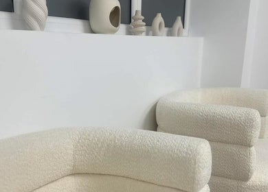 Stylish cream seating with pottery decor at Polished by Asha, Haywards Heath, England, GB.