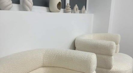 Stylish cream seating with pottery decor at Polished by Asha, Haywards Heath, England, GB.