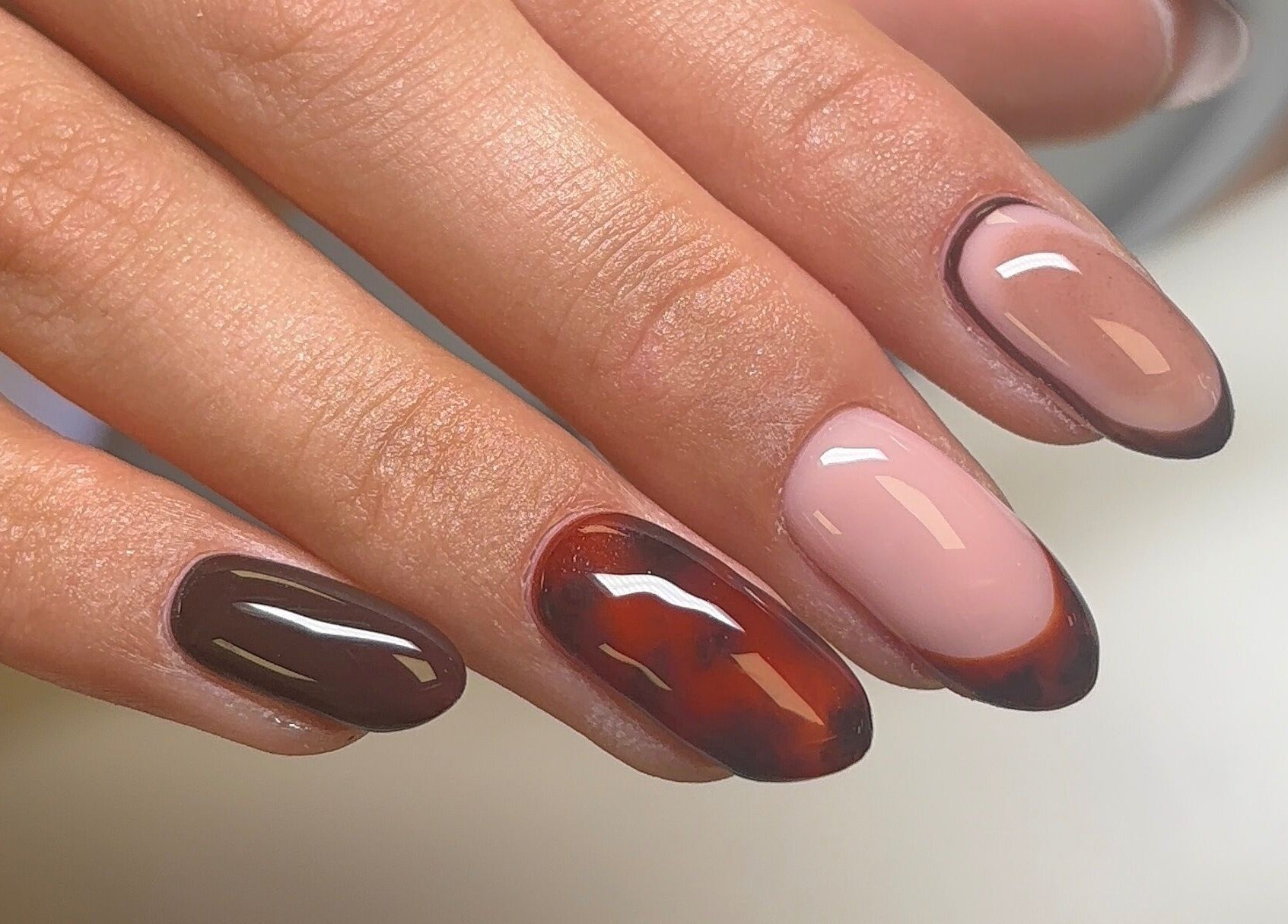 Sophisticated nail art at Polished by Asha, Haywards Heath, England, GB showcasing rich brown and nude hues.