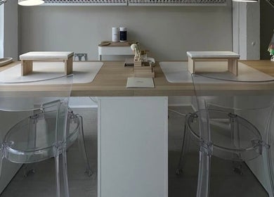 Modern nail station at No10 Beauty & Aesthetics in Woodbridge, England, GB, with clear chairs and elegant setup.