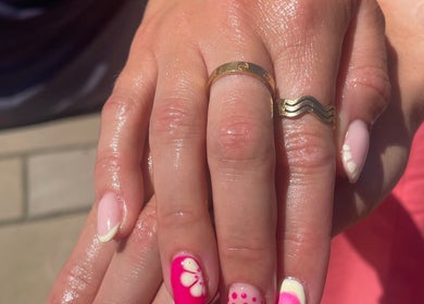 Stylish pink manicure with floral design at No10 Beauty & Aesthetics, Woodbridge, England, GB.