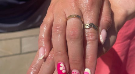 Stylish pink manicure with floral design at No10 Beauty & Aesthetics, Woodbridge, England, GB.