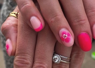 Vibrant pink floral nail art at No10 Beauty & Aesthetics, Woodbridge, England, GB.