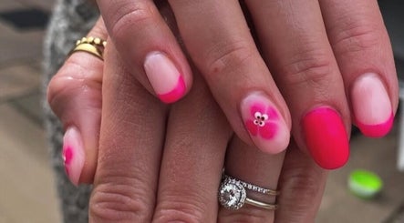 Vibrant pink floral nail art at No10 Beauty & Aesthetics, Woodbridge, England, GB.